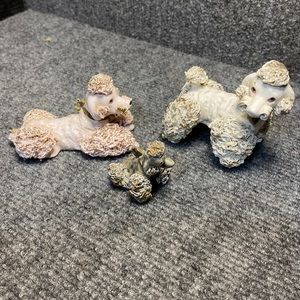 Set of two porcelain spaghetti style poodles one cream color one pale pink.